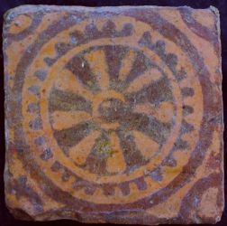 Medieval tile with wheel decoration